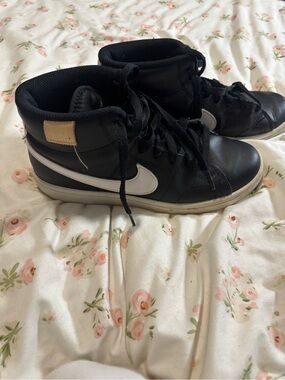 Nike Black High-Top Sneakers with White Swoosh and Cream Tag